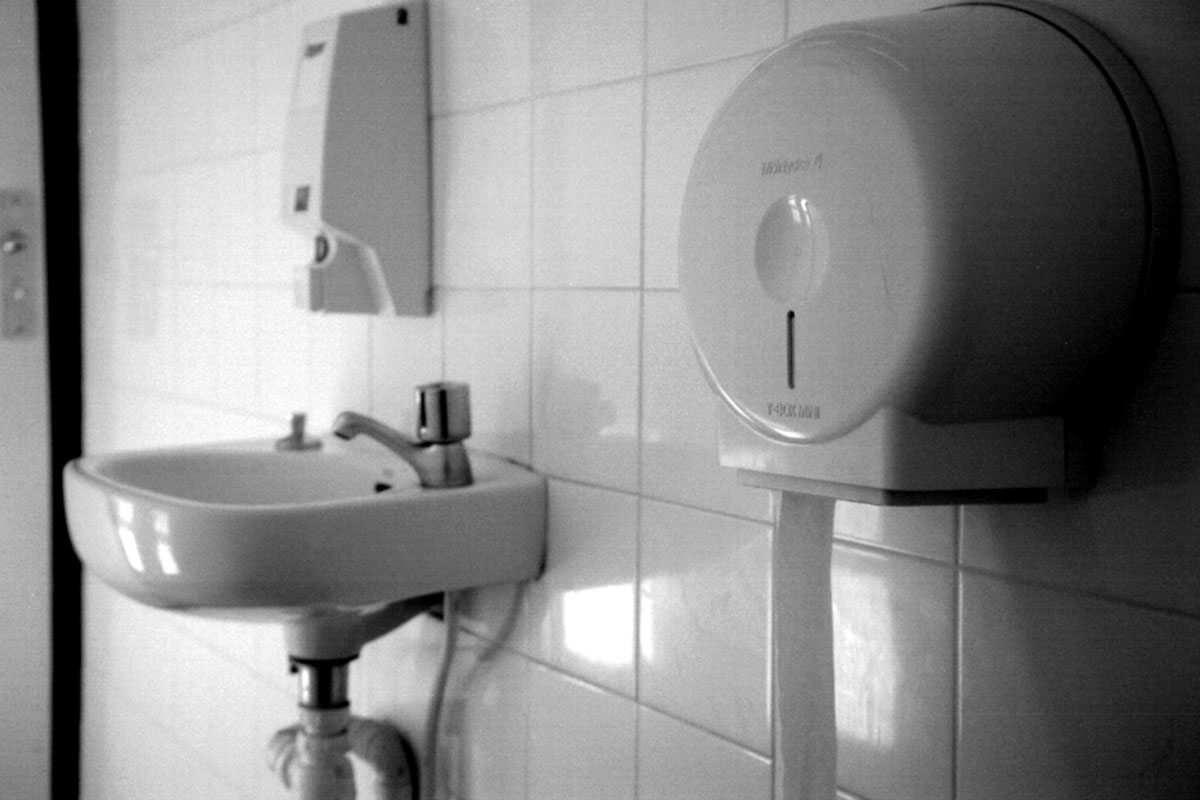 Waschbecken mit Spiegel davor ein Handtuchspender
